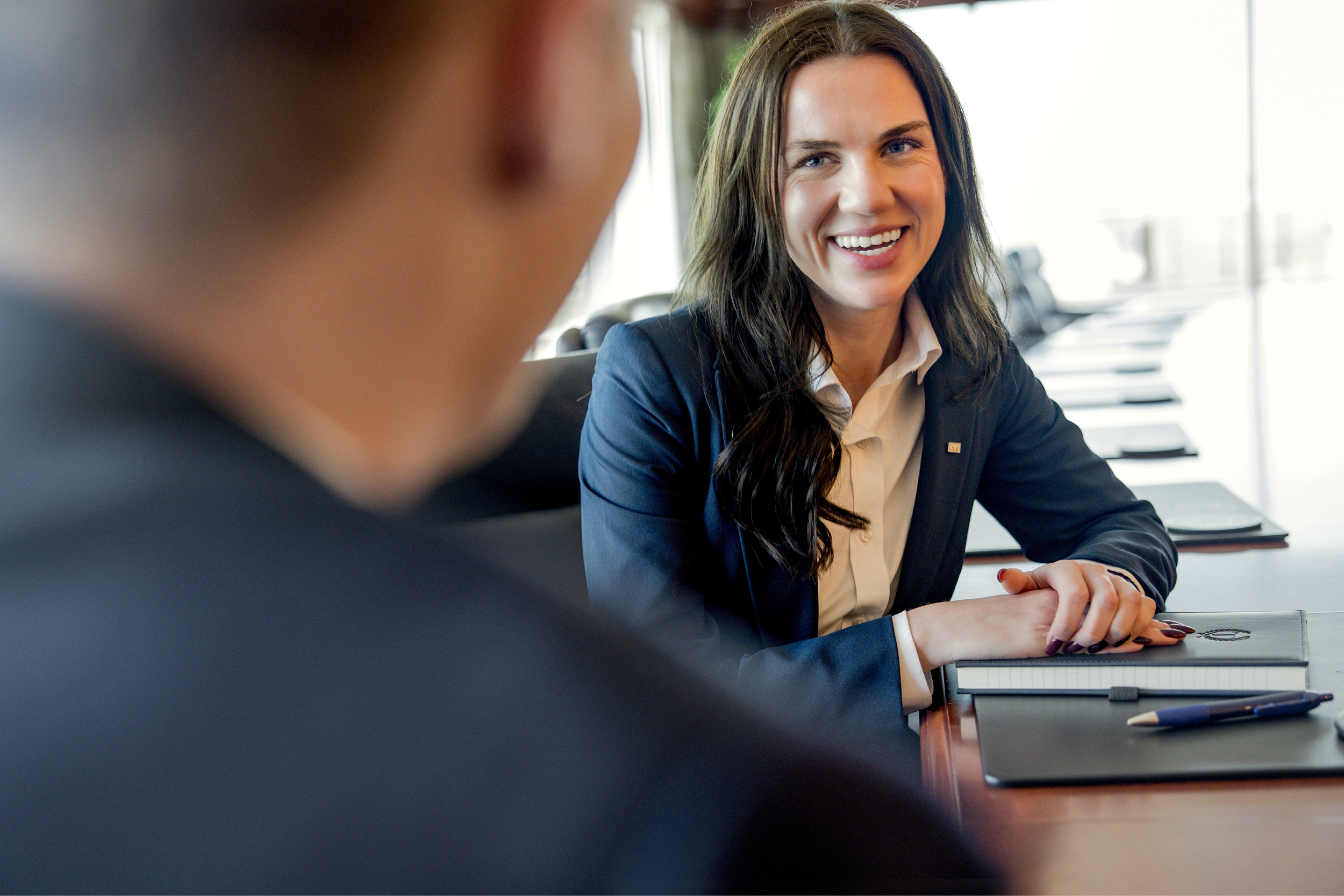 Woman at conference table.