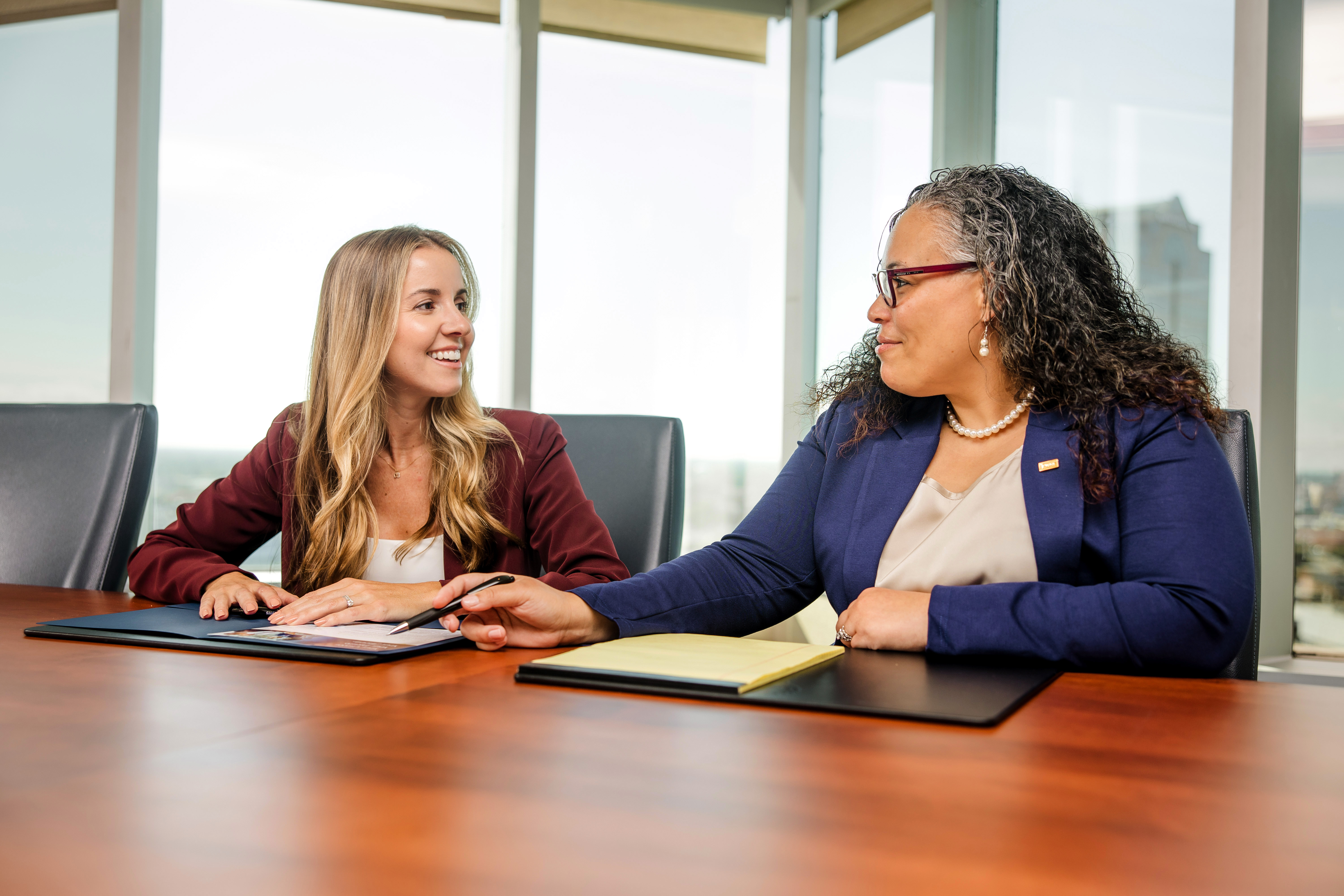 two individuals at a conference table